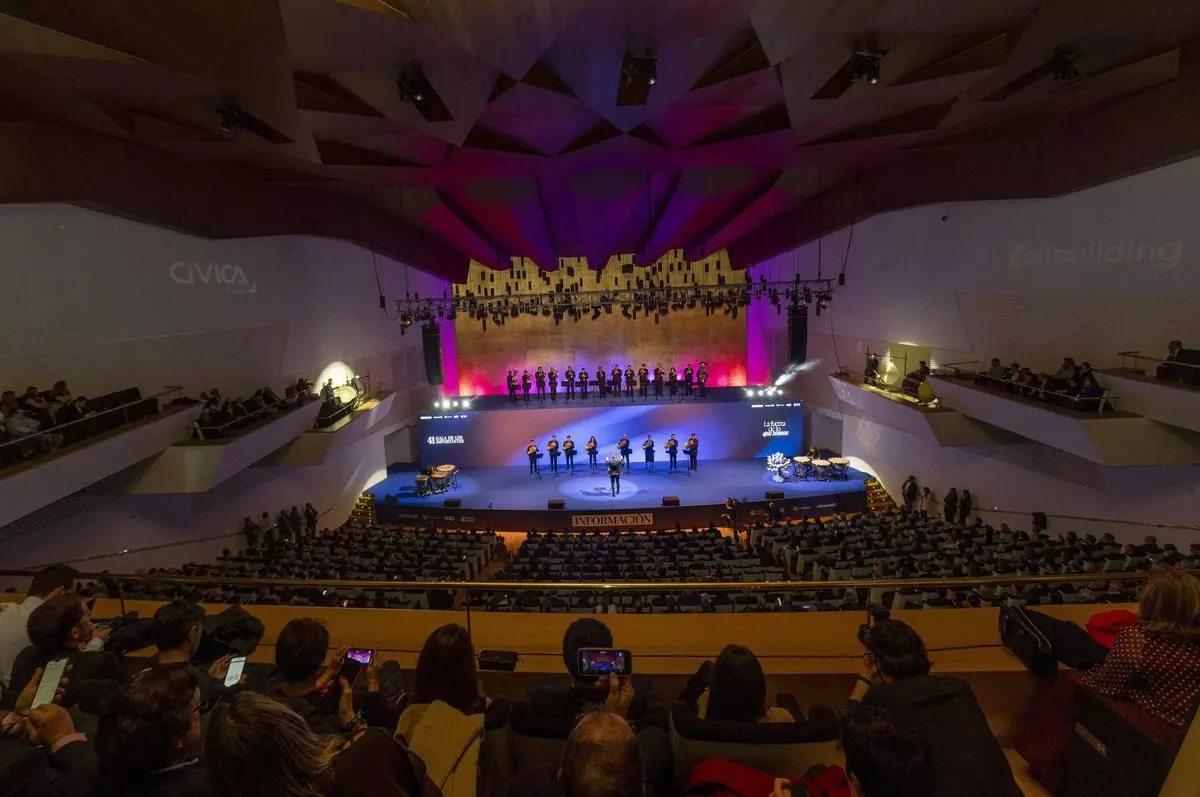 Full stage with performers and dramatic lighting